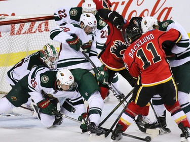 Calgary Flames a and Minnesota Wild pile up in a wild melee in front of the Wild net during the third period of NHL action at the Scotiabank Saddledome on Thursday Jan. 29, 2015. The Wild won the game 1-0.