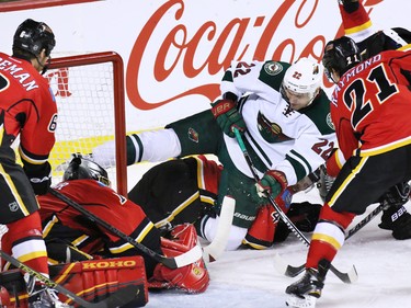 The Flames and Minnesota Wild pile up in front of Calgary Flames goaltender Jonas Hiller during second period NHL action at the Scotiabank Saddledome on Thursday Jan. 29, 2015.
(Gavin Young/Calgary Herald)
(For City section story by Scott Cruikshank) Trax# 00057776A