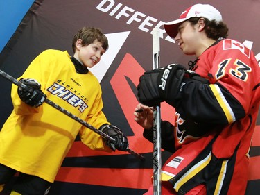 Young Calgary Flames star Johnny Gaudreau signs an autograph for nine year-old Nick Henley of the the Blackfoot Chiefs Atom 5 team at the Acadia Recreation Centre before their practise Friday night. Gaudreau surprised the team in their dressing room in the event sponsored by Bauer. The team also received Bauer hockey sticks and Gaudreau skated with the team during their practise.