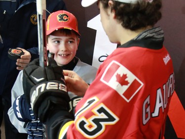 Young Calgary Flames star Johnny Gaudreau signs an autograph for a star struck nine year-old Brendan Churchill of the Blackfoot Chiefs Atom 5 team at the Acadia Recreation Centre before their practise Friday night. Gaudreau surprised the team in their dressing room in the event sponsored by Bauer. The team also received hockey sticks and Gaudreau skated with the team during their practise.