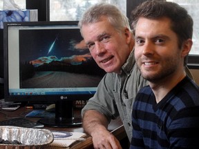 University of Calgary geoscience professor Alan Hilderbrand and research assistant Lincoln Hanton at the university's Earth Sciences office Wednesday, January 21, 2015, in front of the monitor showing the photo of a fireball by photographer Brett Abernethy over Mount Rundle in Banff National Park. The pair is now searching for the asteroid's rare fragments.
