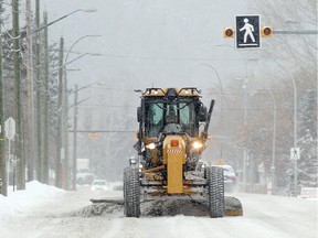 A snowplow chugs along Kensington Road Saturday morning January 31, 2015.