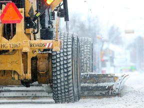 CALGARY, AB.; JANUARY 31, 2015  -- A snowplow chugs along Kensington Road Saturday morning January 31, 2015 as the winter storm overnight left streets slippery and greasy. (Ted Rhodes/Calgary Herald) For City  story by . Trax #