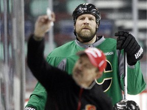 Brian McGrattan of the Calgary Flames listens to the instructions of assistant coach Jacques Cloutier during practice last week. He has been sent to the AHL.