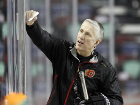 Calgary Flames coach Bob Hartley lays out his plans in x's and o'x during practice at the Saddledome on Monday.