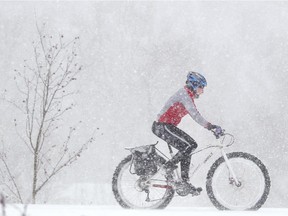 FILE PHOTO — CALGARY, AB. JAN. 7, 2015. A cyclist braves a winter storm on Calgary streets.
