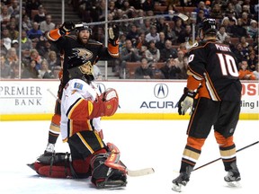 Patrick Maroon and Corey Perry of the Anaheim Ducks react to the goal of Ryan Getzlaf, which gave the Ducks a 5-2 lead in front of Jonas Hiller  of the Calgary Flames during the third period on Wednesday.