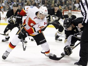 Sean Monahan of the Calgary Flames wins a faceoff against Brandon Sutter of the Pittsburgh Penguins during a game last month. Monahan has been one of the NHL's most prolific winner of draws, but the Flames are thin behind him.
