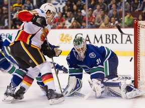 Calgary Flames centre Mikael Backlund shoots the puck past goalie Eddie Lack of the Vancouver Canucks on Saturday. The tally stood up as the winner in a 1-0 Flames triumph.