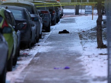 Items on the sidewalk outside the scene of a multiple shooting in Calgary on January 1, 2015.