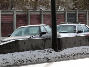 A car appears to have slipped into a cement barricade on Crowchild Trail Sunday morning. Roads and sidewalks were a hazard after an overnight rainfall turned to ice on January 18, 2015.