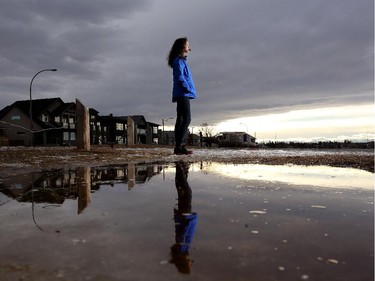 Anastasia Kobra, 11, takes in the view of a chinook arch on a warm winter day in Calgary.