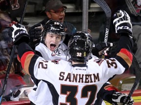 Calgary Hitmen Radel Fazleev, left, celebrates his goal on the Swift Current Broncos with teammates during their game at the Scotiabank Saddledome in Calgary.