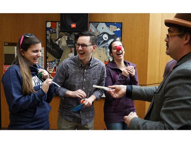 Bailey Powell, David Erickson and Marcelle de Repentigny Lizotte laugh hysterically at the antics of a magician at the U of C during the HaskayneHappyness festival to uplift students spirits, on January 26, 2015.