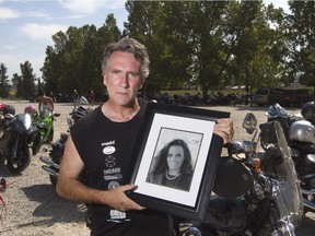 Sean Mahoney holds a picture of his wife Kelli-Jo Smith who died in his arms after their vehicle was struck.