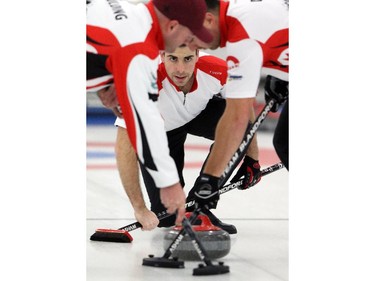 Brent Hamilton reacts to his thrown stone during the Southern Alberta Curling Association play downs at the Okotoks Curling Club, on January 19, 2015.