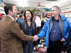 Premier Jim Prentice joined by High River MLA Danielle Smith greeted local MP John Barlow at a High River coffee shop following an announcement regarding changes to the Distaster Recovery Program in High River on January 24, 2015.