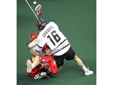 Calgary Roughnecks forward Curtis Dickson had his helmet fly off after a rough hit by Edmonton Rush transition Chris Chris Corbeil during NLL game action at the Scotiabank Saddledome on January 24, 2015.