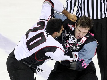 Calgary Hitmen defenceman Colby Harmsworth, right, and Vancouver Giants defenceman Arvin Atwal scrapped during WHL action at the Scotiabank Saddledome on January 25, 2015.