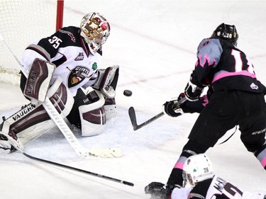 Calgary Hitmen right winger Chase Lang unleashed a shot on Vancouver Giants goalie Cody Porter during WHL action at the Scotiabank Saddledome on January 25, 2015. The Hitmen won the game 8-0.