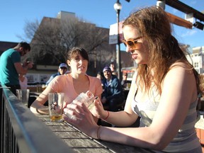 Friends Victoria Garry, left, and Megan Maher decided to enjoy the chinook warm weather by hitting the outdoor patio at The National on 17th Avenue S.W. on January 25, 2015.