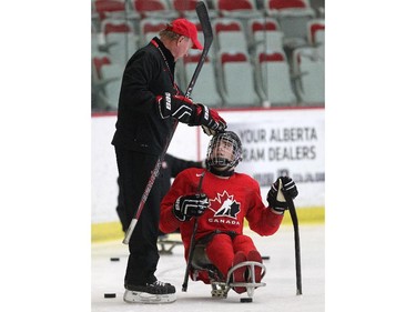 New Canadian sledge hockey coach Ken Babey, left, gave forward Anthony Gale some encouragement during practice at the Markin MacPhail Arena on January 13, 2015.