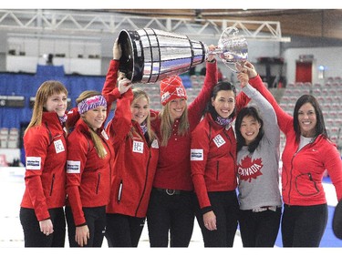 Team Canada curlers, from left, Dawn McEwen, Kaitlyn Lawes, skip Jennifer Jones, Canadian Olympic Cross Country skier Chandra Crawford, curler Jill Officer, Olympic wrestler Carol Huynh and golfer Lisa "Longball" Vlooswyk hoisted the Grey Cup after playing a one end fun exhibition match to kick off the Continental Cup at the Markin MacPhail Arena at Winsport January 7, 2015. TheGrey Cup was brought to the match by Calgary Stampeders Rob Cote and Anthony Parker who played on the Brad Jacobs team for the fun game.