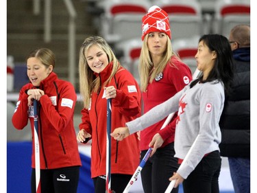 Team Canada curler Jennifer Jones, second from left, laughed as Canadian Olympic wrestler Carol Huynh, right, demonstrated her delivery on the ice during an fun exhibition match to kick off the Continental Cup at the Markin MacPhail Arena at Winsport January 7, 2015.