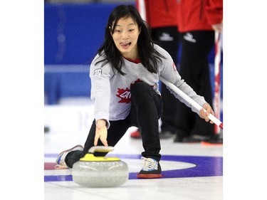 Canadian Olympic wrestler Carol Huynh delivered the rock during an fun exhibition match between Teams Jennifer Jones and Brad Jacobs with local athletes to kick off the Continental Cup at the Markin MacPhail Arena at Winsport January 7, 2015.