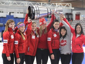 Team Canada curlers, from left, Dawn McEwen, Kaitlyn Lawes, skip Jennifer Jones, Canadian Olympic Cross Country skier Chandra Crawford, curler Jill Officer, Olympic wrestler Carol Huynh and golfer Lisa "Longball" Vlooswyk hoisted the Grey Cup after playing a one end fun exhibition match to kick off the Continental Cup at the Markin MacPhail Arena at Winsport on Wednesday morning. The Grey Cup was brought to the match by Calgary Stampeders Rob Cote and Anthony Parker who played on the Brad Jacobs team for the fun game.