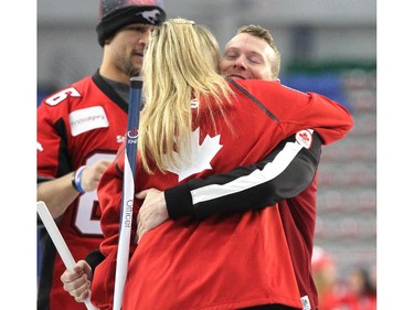 Team Canada curler Jennifer Jones gave Olympic gymnast Kyle Shewfelt a hug at the end of a fun exhibition match to kick off the Continental Cup at the Markin MacPhail Arena at Winsport January 7, 2015.