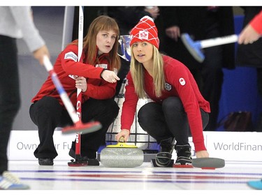 Team Canada curler Dawn McEwen helped Canadian Olympic cross country skier Chandra Crawford on the ice during an fun exhibition match between Team Jennifer Jones and Brad Jacobs to kick off the Continental Cup at the Markin MacPhail Arena at Winsport January 7, 2015.
