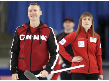 Team Canada curler Dawn McEwen, right, kept an eye on a shot by Canadian Olympic gymnast Kyle Shewfelt during an fun exhibition match between Team Jennifer Jones and Brad Jacobs to kick off the Continental Cup at the Markin MacPhail Arena at Winsport January 7, 2015.