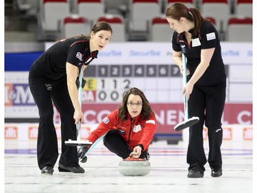 Team Canada curler Val Sweeting, centre, released her shot into the hands of her sweepers Rachel Brown, left, and Dana Ferguson during her game against Team Europe's Anna Sidorova during the opening round of team action in the Continental Cup at the Markin MacPhail Arena at Winsport January 8, 2015. Sweeting lost in her opening game.