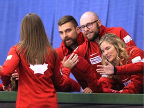 Team Canada members high fived skip Rachel Homan after she won her game against Team Europe's Marcaretha Sigfriddsson during the opening round of team action in the Continental Cup at the Markin MacPhail Arena on Thursday.