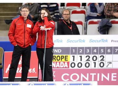 Team Canada curler Val Sweeting talked with coach Rick Lang as she had her hands full while trailing in her game against Team Europe's Anna Sidorova during the opening round of team action in the Continental Cup at the Markin MacPhail Arena at Winsport January 8, 2015.