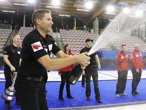 Chestermere's John Morris celebrates with champagne after Team Canada won the Continental Cup at the Markin McPhail Centre in Calgary on Sunday.