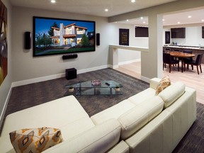 A media room just a few steps away from a wet bar in this development basement in a home by Prominent Homes.