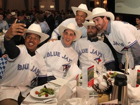 Members of the Toronto Blue Jays, including current players Marcus Stroman, left, Aaron Sanchez, Drew Hutchison and Kevin Pillar, along with former Blue Jay Roberto Alomar in behind took a selfie after getting white hatted at the Calgary Baseball Luncheon on Thursday. The event supported the Okotoks Dawgs Youth Baseball Academy and amateur baseball in Alberta.