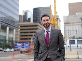Adam Hayes, principal with real estate company Cresa stands near some downtown construction in Calgary, Alberta on August 23, 2013.
