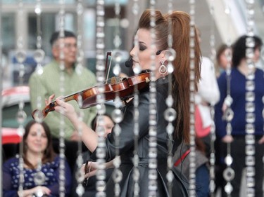Renowned violinist Sophie Serafino performs a three song pop up concert over the noon hour Thursday January 29, 2015 at the Fifth Avenue Place atrium. A native of Australia she now lives in Calgary. The performance was a preview of her debut performance of The Crystal Violin February 7 at Royal Oak Audi.