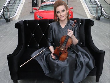 Renowned violinist Sophie Serafino poses for photos after her three song pop up performance over the noon hour Thursday January 29, 2015 at the Fifth Avenue Place atrium. A native of Australia she now lives in Calgary. The performance was a preview of her debut performance of The Crystal Violin February 7 at Royal Oak Audi.
