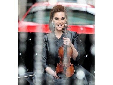 Renowned violinist Sophie Serafino poses for photos after her three song pop up performance over the noon hour Thursday January 29, 2015 at the Fifth Avenue Place atrium. A native of Australia she now lives in Calgary. The performance was a preview of her debut performance of The Crystal Violin February 7 at Royal Oak Audi.