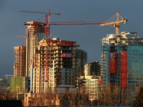 Residential condo construction projects in the East Village and in the distance Victoria Park are lit by the rising sun on Tuesday November 25, 2014.