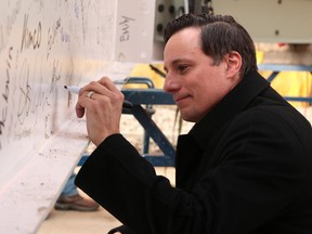 National Music Centre President and CEO Andrew Mosker signed the final beam during the ceremony to place the last structural beam of the new National Music Centre on Dec. 12. The project continues to collect donations.