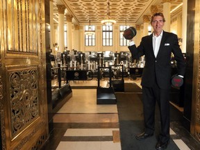 Founder of Goodlife Fitness, David Patchell-Evans, stands at the front doors of his newest location in Calgary inside the historic Bank of Montreal building on January 13, 2015.