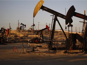 Pump jacks proliferate in an oilfield in California.