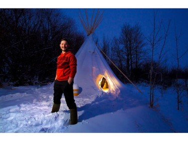 Connor Ferster stands outside his teepee east of Calgary on December 3, 2013.