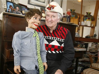 Ron Barge, on the 40th anniversary of the first episode of his CFCN show Buck Shot, wearing his famous hat, posing with a puppet called Farley Frick.