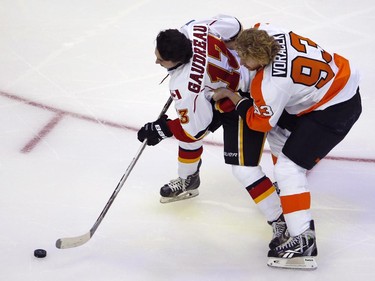 Calgary Flames' Johnny Gaudreau (13), is helped by Philadelphia Flyers' Jakub Voracek (93), during the Breakaway competition at the NHL All-Star hockey skills competition in Columbus, Ohio, Saturday, Jan. 24, 2015.